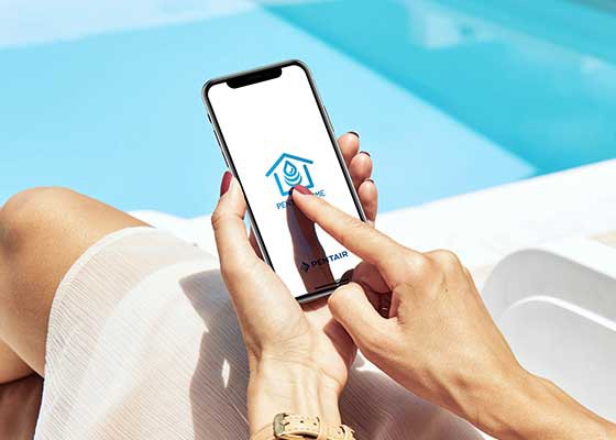 woman on phone next to clear blue pool with 6Ͽʿ Home app 
